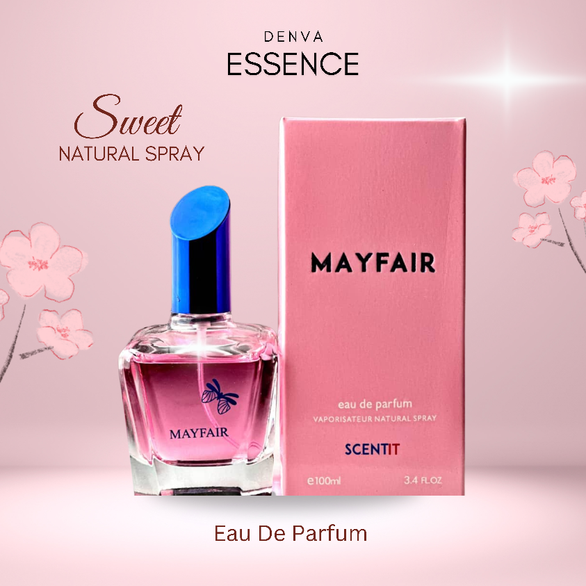 A product shot of Denva Essence Mayfair perfume. The clear glass bottle with a bright blue cap is positioned next to its pink box. Both display the "Mayfair" name. The background is a gradient from white to pink with stylized pink flower outlines. Text elements include "Sweet Natural Spray," "Eau de parfum," "VAPORISATEUR NATURAL SPRAY," "SCENTIT," "e100ml," and "3.4 FL.OZ." The Denva Essence logo is at the top.