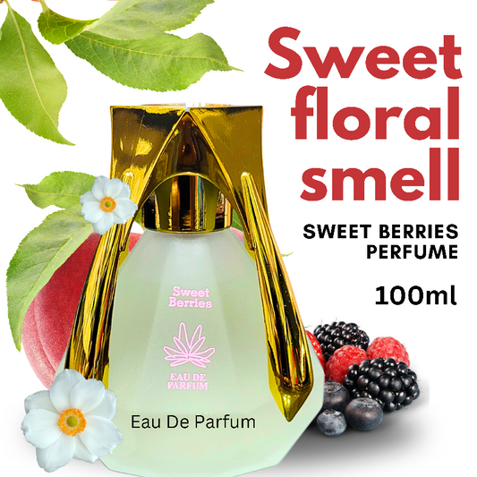 A photo of the Sweet Berries Perfume bottle. The bottle is made of clear glass with a faceted diamond shape and a gold cap. The label on the bottle reads "Sweet Berries" and "Eau de Parfum." The image also shows a peach, berries, and flowers, suggesting the perfume's sweet floral scent.