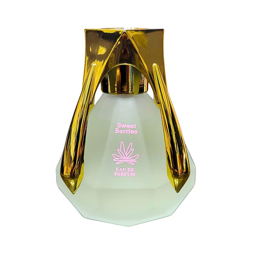 A photo of the Sweet Berries Perfume bottle. The bottle is made of clear glass with a faceted diamond shape and a gold cap. The label on the bottle reads "Sweet Berries" and "Eau de Parfum."