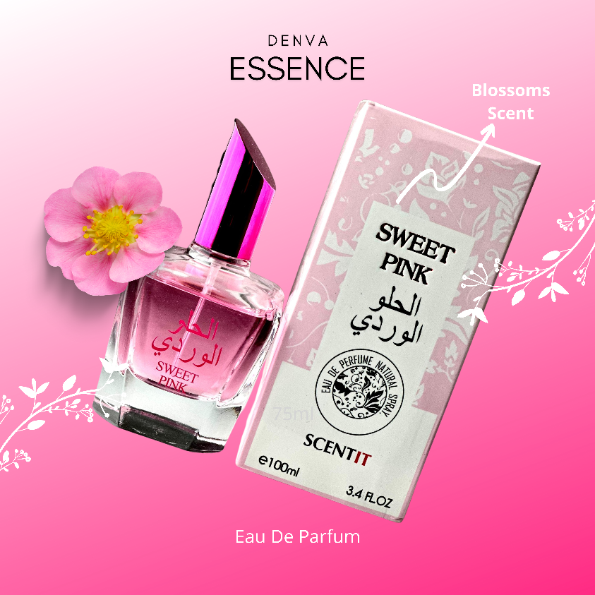 A close-up product shot of Denva Essence Sweet Pink perfume. The perfume bottle, with its pink liquid and fuchsia cap, sits next to its matching box. A small pink flower rests near the bottle, and the background blends from white to pink. The text "Sweet Pink" is visible on both the bottle and box, along with Arabic script and the brand name "Denva Essence." Other text includes "Blossoms Scent," "Eau De Parfum," "SCENTIT," "e100ml," and "3.4 FL.OZ."